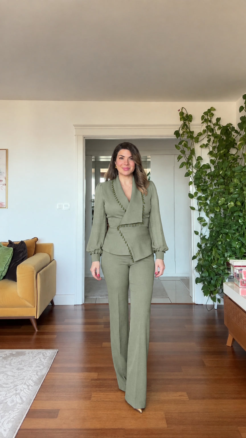 Full-length front view of woman wearing sage green beaded blazer and wide leg pants suit set