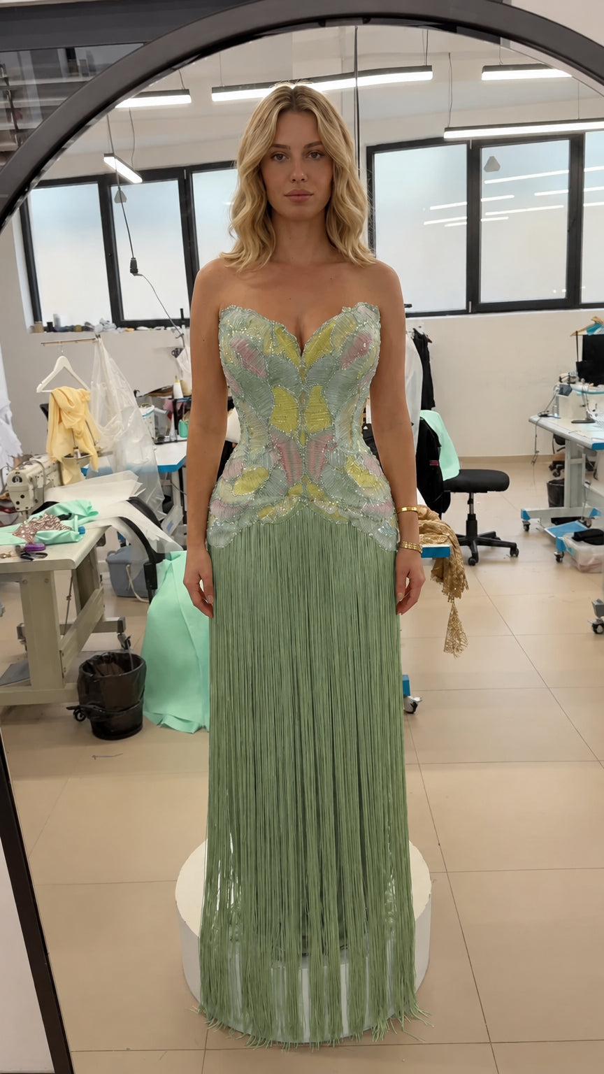 Front view of strapless beaded corset fringe evening gown in sage green