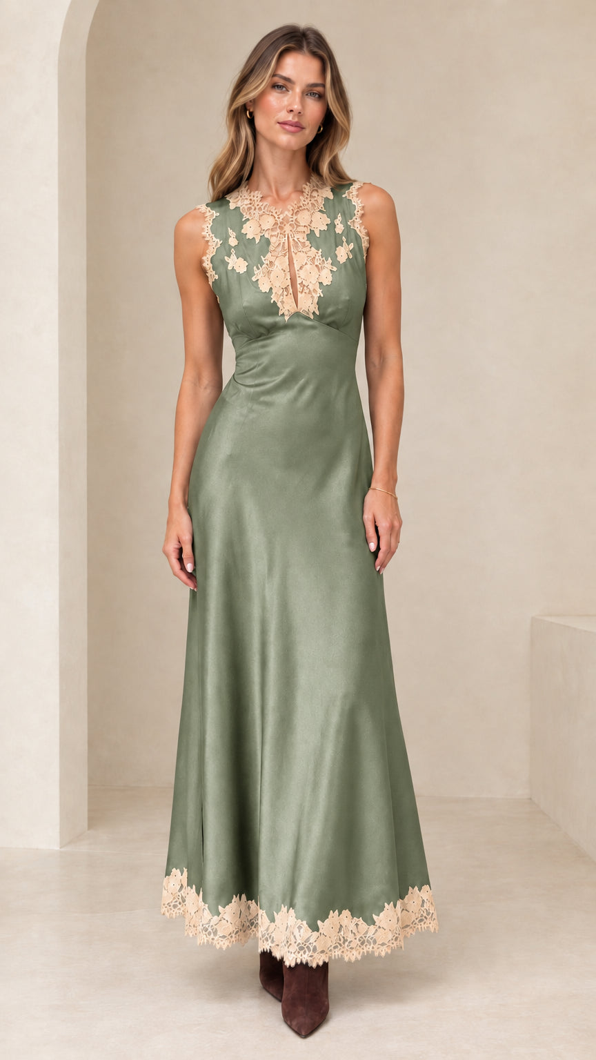 Model wearing sage green satin maxi dress with floral lace details