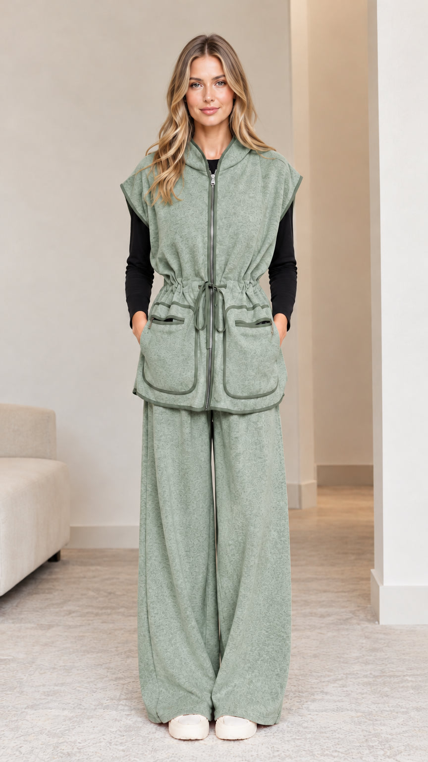 Model wearing sage green 2-piece hooded vest and wide-leg pants set