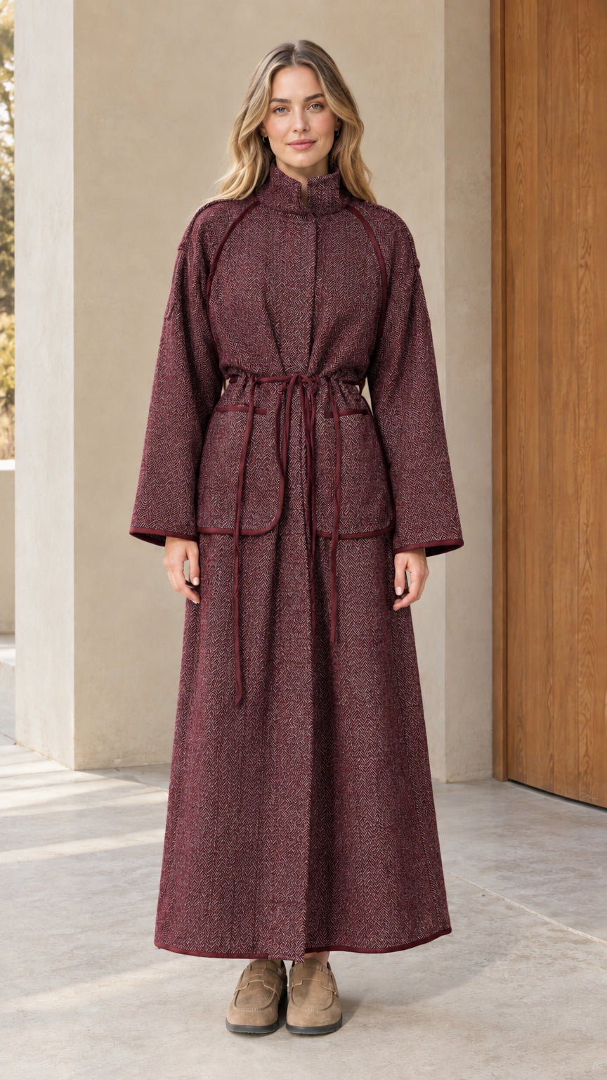 Full-length view of woman wearing rich burgundy wine herringbone maxi coat