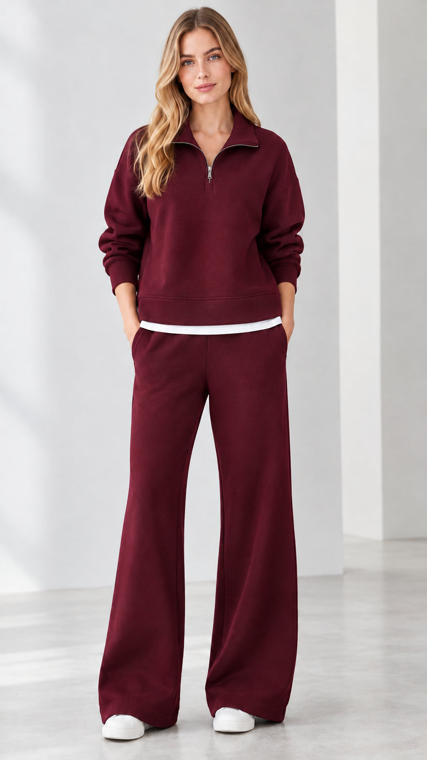 Front view of model wearing burgundy red quarter-zip sweatshirt and wide-leg sweatpants set