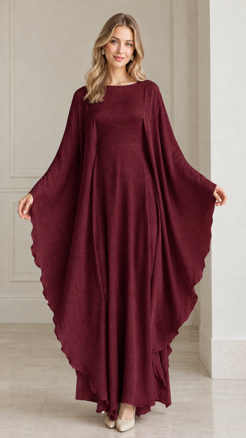 Front view of woman wearing burgundy wine red draped cape formal gown