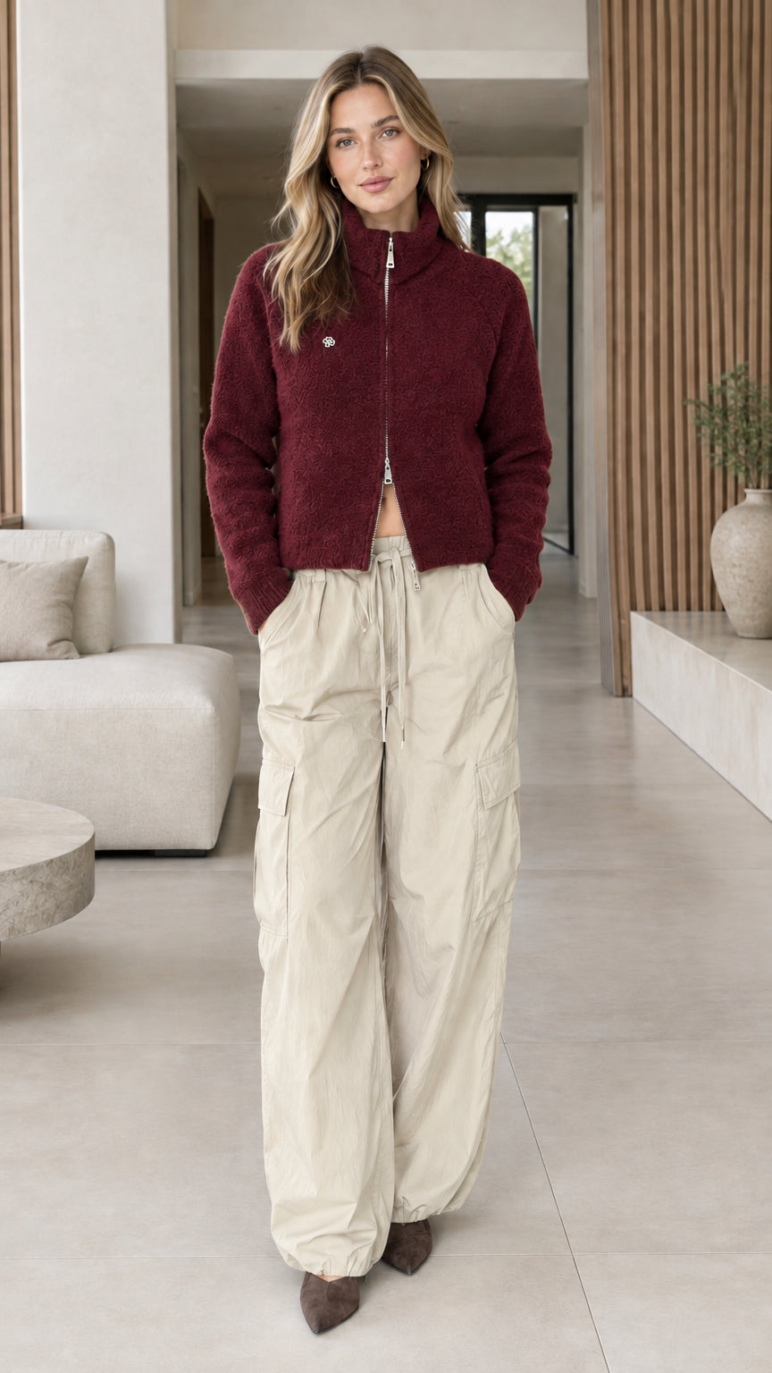 Model wearing burgundy red textured fleece stand collar zip-up jacket
