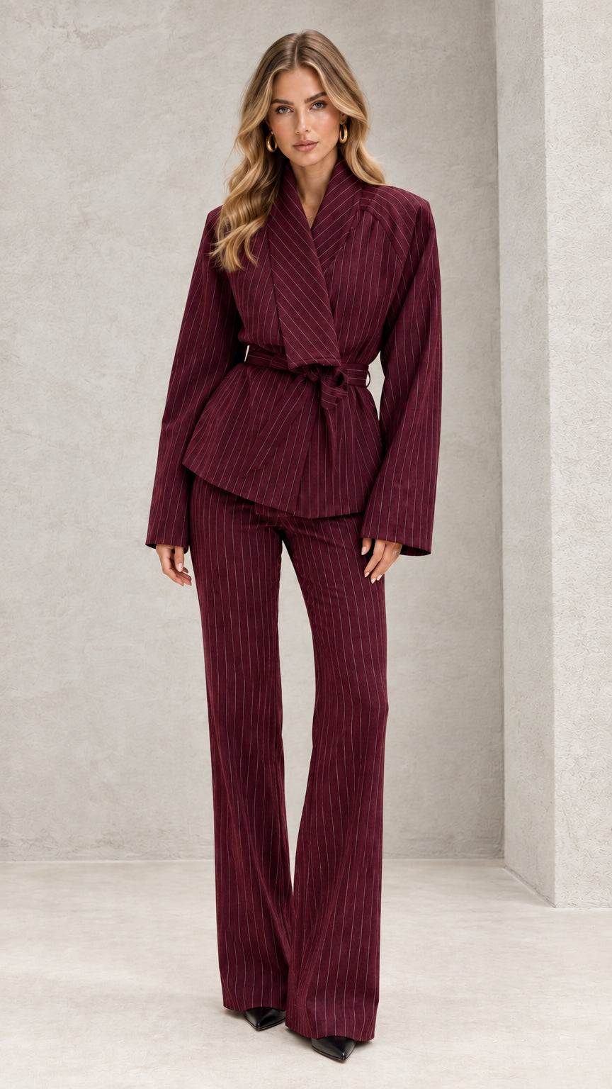 Front view of model wearing burgundy red pinstripe belted two-piece suit