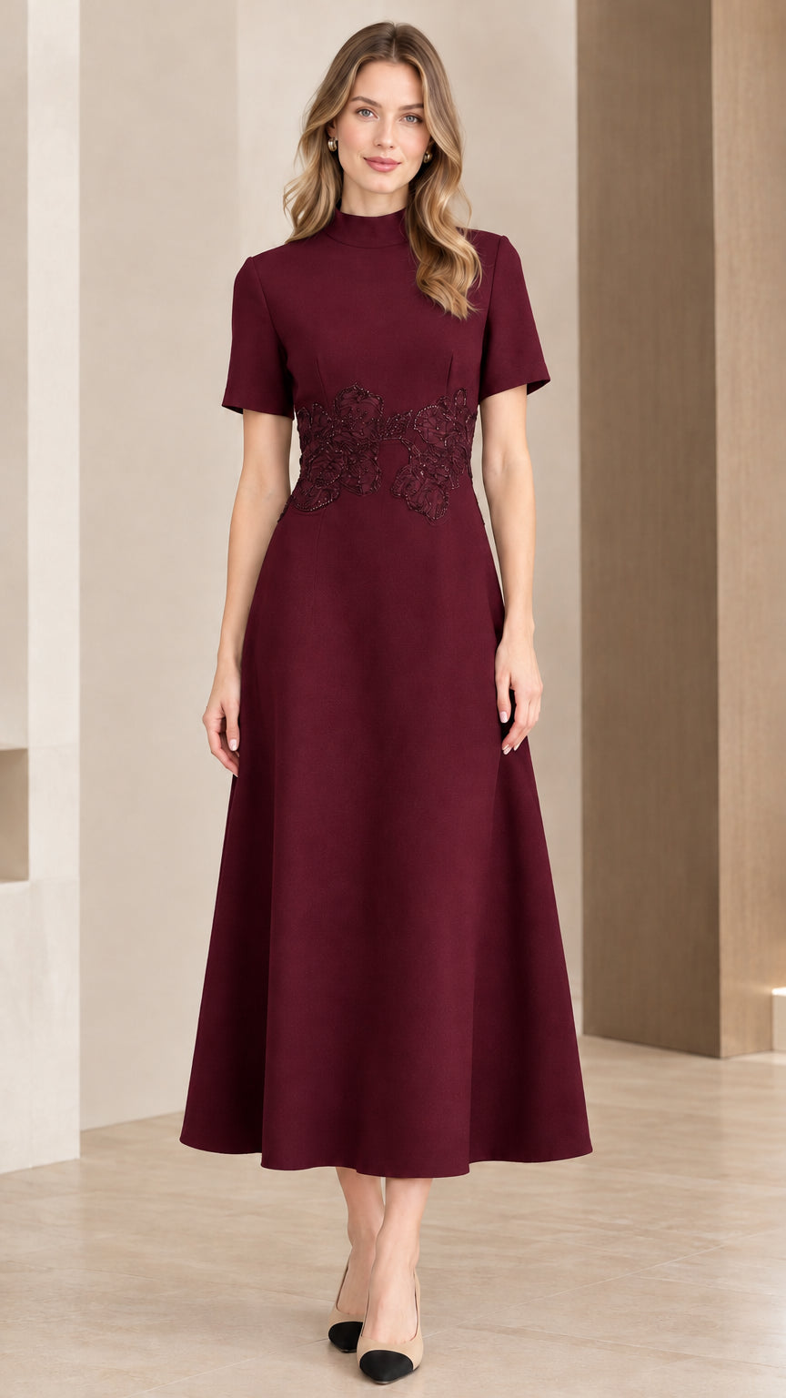 Woman wearing burgundy wine mock neck fit and flare dress with waist embellishment