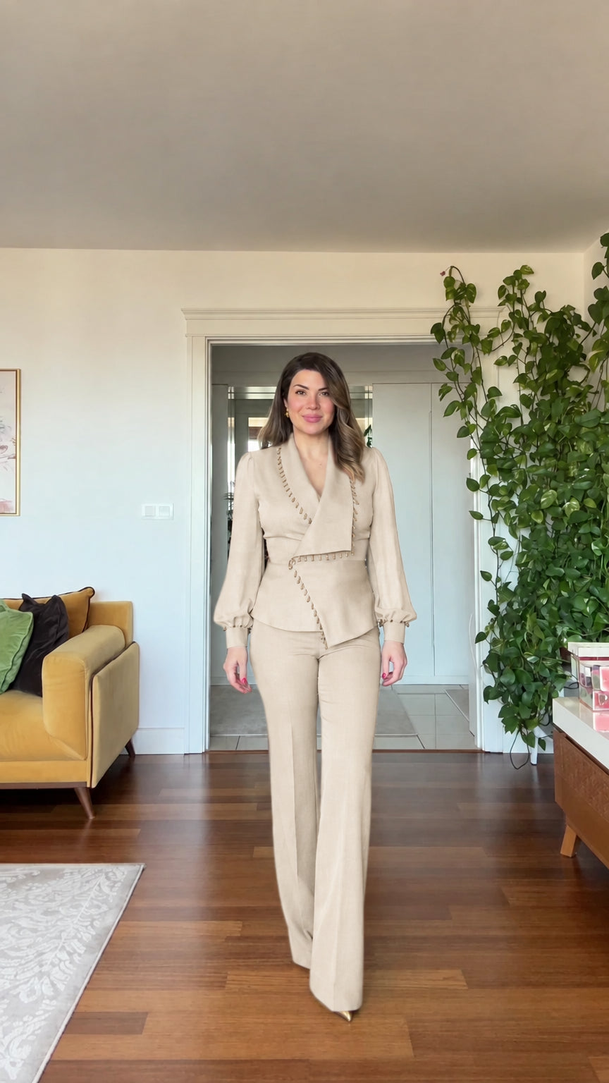 Full-length front view of woman wearing beige cream beaded blazer and wide leg pants suit set