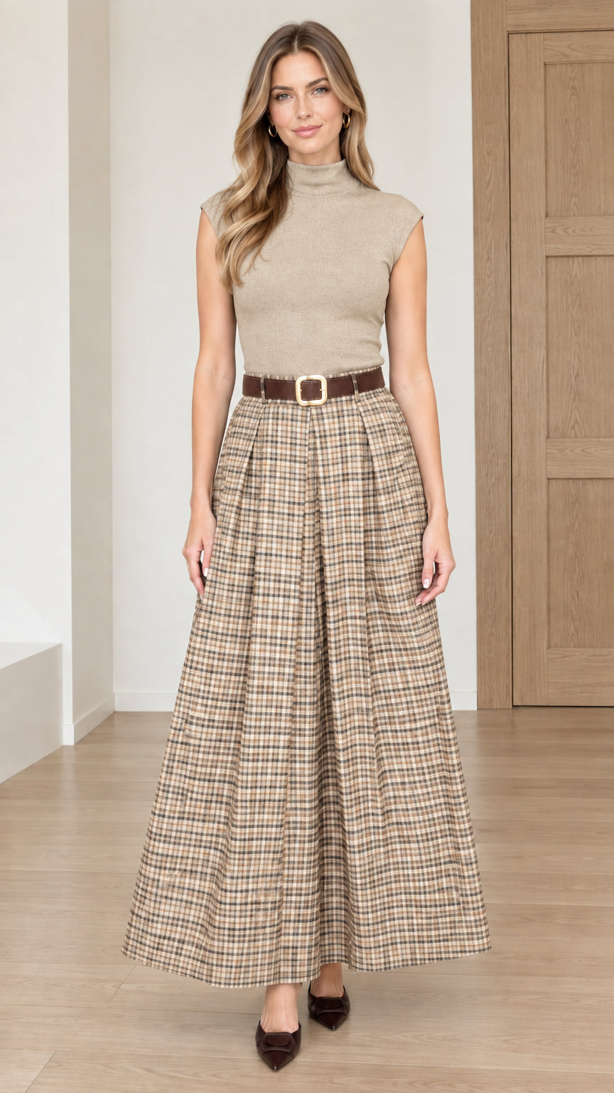 Model wearing beige khaki plaid pleated maxi skirt with neutral knit top