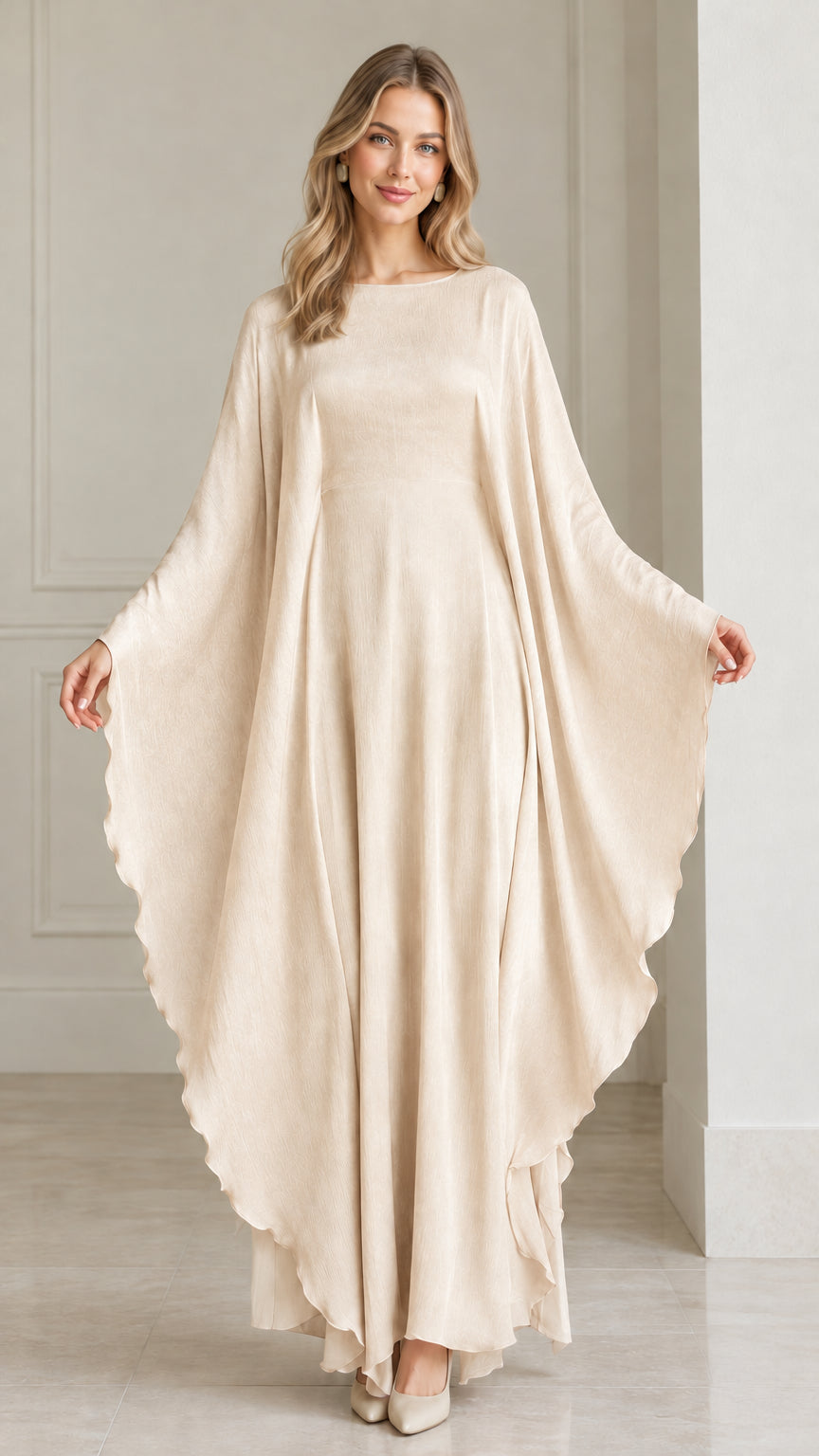 Front view of woman wearing champagne cream draped cape maxi dress